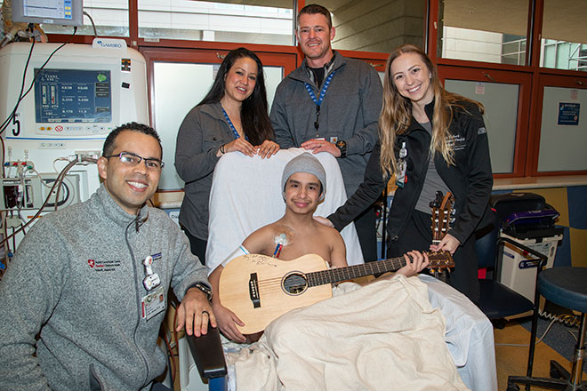 Kayano Lizardo-Bristow holds his Ed Sheeran-inscribed guitar